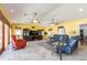 Bright living room features a vaulted ceiling, tile floors, ceiling fans, large windows, and comfortable seating at 1140 81St S St, St Petersburg, FL 33707