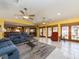 Large living room features an open layout, tile floors, ceiling fans, a dining area, and access to the outdoor pool at 1140 81St S St, St Petersburg, FL 33707