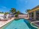 Inviting backyard featuring a pool, spa, brick patio, lush landscaping, and serene outdoor living space at 1140 81St S St, St Petersburg, FL 33707
