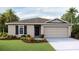 Charming single-story home featuring a neutral palette, a two-car garage, and well-maintained landscaping at 1210 Cape Chestnut Pl, Ruskin, FL 33570