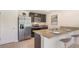 Bright kitchen featuring stainless steel appliances, dark cabinetry, granite countertops, and a breakfast bar at 1210 Cape Chestnut Pl, Ruskin, FL 33570