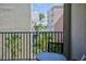 Cozy balcony view featuring a table, chairs, and palm trees at 12924 Gulf Blvd # 310, Madeira Beach, FL 33708
