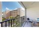 Relaxing balcony featuring seating and views of the building and surrounding landscaping at 12924 Gulf Blvd # 310, Madeira Beach, FL 33708