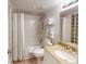Bathroom featuring tub/shower combination, ample counter space, and neutral tile flooring at 12924 Gulf Blvd # 310, Madeira Beach, FL 33708
