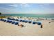 Picturesque beach scene with blue water, lounge chairs, and vacationers enjoying the sunny weather at 12924 Gulf Blvd # 310, Madeira Beach, FL 33708