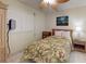 Bright bedroom features a tropical ceiling fan and floral bedding at 12924 Gulf Blvd # 310, Madeira Beach, FL 33708