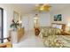 Bedroom boasting two beds, dresser, tropical accents, and bathroom access at 12924 Gulf Blvd # 310, Madeira Beach, FL 33708