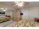 Bright bedroom with floral bedding, a ceiling fan, and a mirrored closet for ample storage at 12924 Gulf Blvd # 310, Madeira Beach, FL 33708