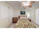 Bedroom with a tropical ceiling fan, floral bedding, and a bright, airy ambiance at 12924 Gulf Blvd # 310, Madeira Beach, FL 33708