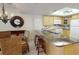 Open kitchen features granite countertops, stainless sink, and wooden cabinets at 12924 Gulf Blvd # 310, Madeira Beach, FL 33708