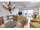 Living room featuring a large dining table and a sliding glass door to the balcony at 12924 Gulf Blvd # 310, Madeira Beach, FL 33708