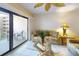 Living room with sliding glass doors to the balcony and casual furnishings at 12924 Gulf Blvd # 310, Madeira Beach, FL 33708