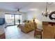 Living room and dining area combination with a sliding glass door to the balcony at 12924 Gulf Blvd # 310, Madeira Beach, FL 33708