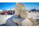 Stunning sand sculpture on display at the beach with the ocean and people in the background at 12924 Gulf Blvd # 310, Madeira Beach, FL 33708