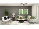 Comfortable living room featuring a gray sofa, modern art, and stylish decor at 13150 Empress Jewel Trl, Parrish, FL 34219