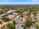 Aerial view of community, showcasing tennis courts, mature trees, and convenient location with surrounding neighborhoods at 1318 Moreland Dr # 108, Clearwater, FL 33764