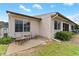 Charming back patio ideal for outdoor seating, surrounded by a well-maintained lawn and mature landscaping at 1318 Moreland Dr # 108, Clearwater, FL 33764