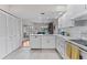 Bright kitchen features white cabinets, tile backsplash, and stainless steel appliances at 1318 Moreland Dr # 108, Clearwater, FL 33764