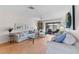 Bright living room with wood floors, comfortable furniture, and sliding glass doors at 1318 Moreland Dr # 108, Clearwater, FL 33764