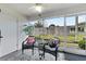 Relaxing sunroom featuring cozy seating, neutral rug, ceiling fan, and views of the private backyard at 1318 Moreland Dr # 108, Clearwater, FL 33764