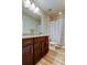Bathroom features a granite countertop vanity, wood look flooring, and a shower with a patterned curtain at 13217 Canopy Creek Dr, Tampa, FL 33625