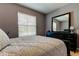 Comfortable bedroom features a large window, dresser, and a cozy bed with patterned bedding at 13217 Canopy Creek Dr, Tampa, FL 33625