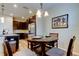 Cozy dining area with modern table set, adjoins the kitchen and stainless steel refrigerator at 13217 Canopy Creek Dr, Tampa, FL 33625