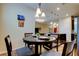 Cozy dining area with a round table, seating for four, and a view of the modern kitchen at 13217 Canopy Creek Dr, Tampa, FL 33625