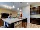 Modern kitchen with granite countertops, stainless steel appliances, and dark wood cabinets at 13217 Canopy Creek Dr, Tampa, FL 33625