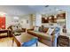 Comfortable living room featuring stylish sofas, decorative pillows, and an open layout leading to the kitchen at 13217 Canopy Creek Dr, Tampa, FL 33625