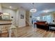 Open-concept living space with wood floors, modern lighting, and a view of the staircase at 13217 Canopy Creek Dr, Tampa, FL 33625