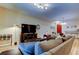 Spacious living room featuring a large TV, comfortable seating, and stylish decor at 13217 Canopy Creek Dr, Tampa, FL 33625