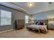 Bright main bedroom features tray ceiling, two windows, and neutral color scheme at 13217 Canopy Creek Dr, Tampa, FL 33625