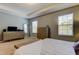 Spacious main bedroom with dual dressers, side tables, a window and a full length mirror at 13217 Canopy Creek Dr, Tampa, FL 33625