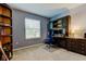 Functional home office with built-in desk, shelving, and natural light at 13217 Canopy Creek Dr, Tampa, FL 33625