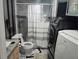 A compact bathroom featuring modern fixtures, a shower-tub combination, and a convenient washing machine setup at 1329 Tuscola St, Clearwater, FL 33756