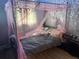 Bedroom featuring a bed with a canopy and decorative wallpaper at 1329 Tuscola St, Clearwater, FL 33756