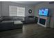 Cozy living room with a comfortable gray sectional sofa, a white fireplace and wood-look flooring at 1329 Tuscola St, Clearwater, FL 33756