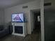 A living room boasts a modern fireplace, a flat-screen TV, and access to the hallway at 1329 Tuscola St, Clearwater, FL 33756