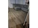 Comfortable living room with a gray sectional sofa, wood-look flooring, and natural light at 1329 Tuscola St, Clearwater, FL 33756
