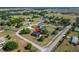 Beautiful aerial view of a charming home, expansive yard, nearby streets, and surrounding neighborhood under a clear blue sky at 14807 Capps Estates Ln, Wimauma, FL 33598