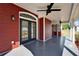 Back porch with ceiling fan and french doors, provides a comfortable transition from indoors to the expansive yard at 14807 Capps Estates Ln, Wimauma, FL 33598