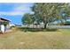 Expansive backyard featuring a wooden gazebo, manicured lawn, and a privacy fence, offering a private oasis at 14807 Capps Estates Ln, Wimauma, FL 33598