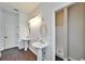 Elegant bathroom with pedestal sinks, decorative mirrors, and a bright, tiled shower at 14807 Capps Estates Ln, Wimauma, FL 33598