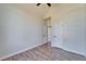 This bedroom includes neutral walls, wood look flooring and a pair of doors, one leading to the closet at 14807 Capps Estates Ln, Wimauma, FL 33598
