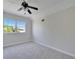 Bright bedroom featuring a ceiling fan and a large window with natural light at 14807 Capps Estates Ln, Wimauma, FL 33598