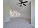 Expansive bonus room features plush carpeting, vaulted ceilings, and multiple ceiling fans at 14807 Capps Estates Ln, Wimauma, FL 33598