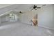 Spacious bonus room with carpet, vaulted ceilings, staircase, and multiple ceiling fans at 14807 Capps Estates Ln, Wimauma, FL 33598