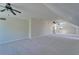 Large bonus room featuring carpet, vaulted ceilings, natural light, and multiple ceiling fans at 14807 Capps Estates Ln, Wimauma, FL 33598