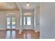 Inviting entryway with wood floors and a stylish front door with decorative glass at 14807 Capps Estates Ln, Wimauma, FL 33598